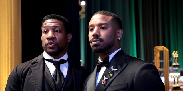 Michael B. Jordan and Jonathan Majors pose backstage at the Oscars