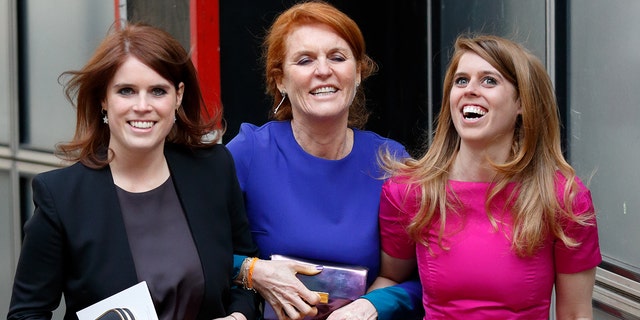 Sarah Ferguson holding onto her two daughters