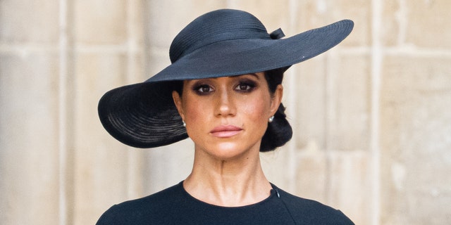 Meghan Markle wears a black dress and a black hat at Queen Elizabeths funeral.