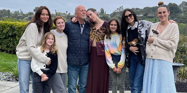 Bruce Willis, Emma Willis, Demi Moore and their children posing for a picture while celebrating his birthday