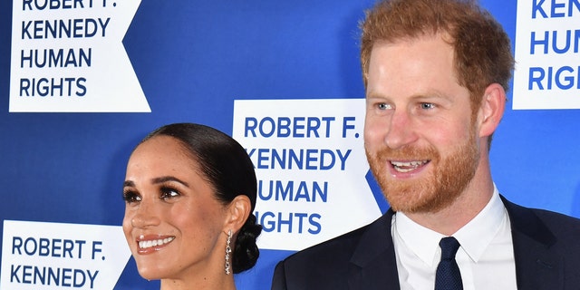 Meghan Markle and Prince Harry smile at a red carpet event