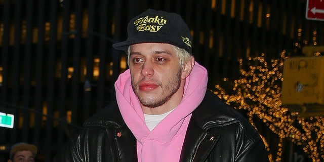 Pete Davidson walks in New York wearing a pink hoodie