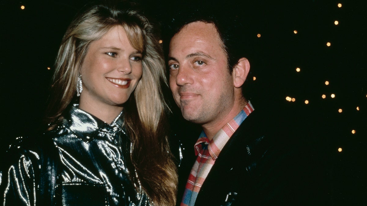 Christie Brinkley and Billy Joel hugging