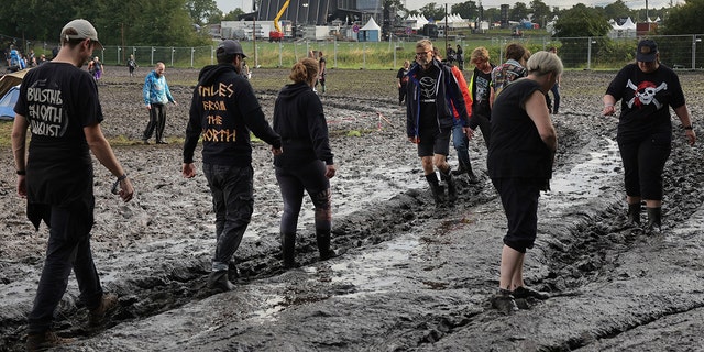 Fans walking through the mud at The Wacken Open Air festival in Germany