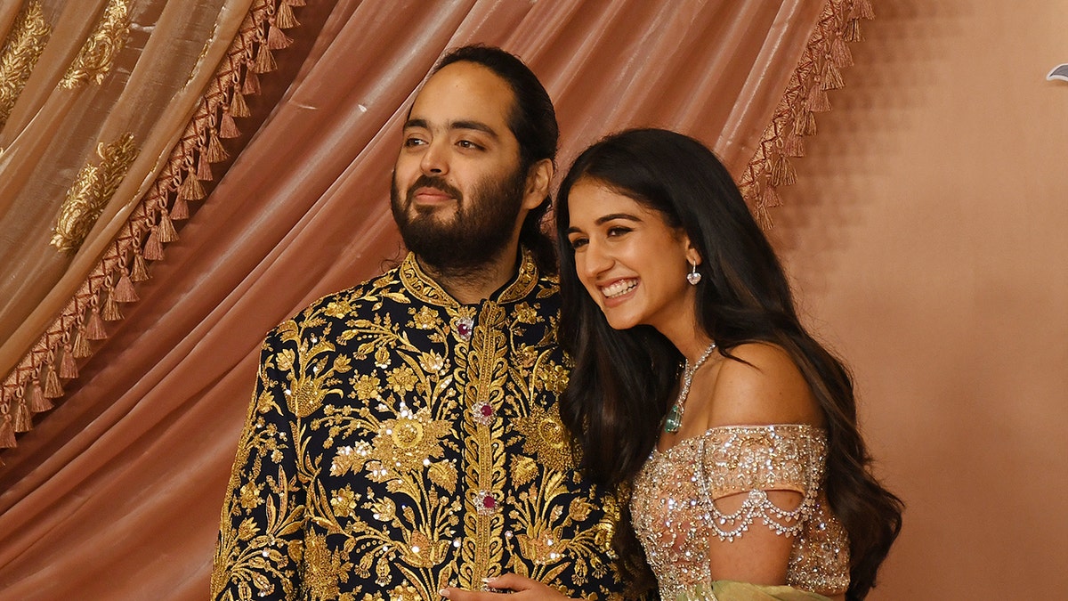 Anant Ambani (son of Indian businessman Mukesh Ambani) and his fiancée Radhika Merchant posing together