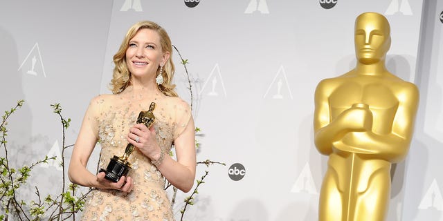 Cate Blanchett holding her Oscar in 2014