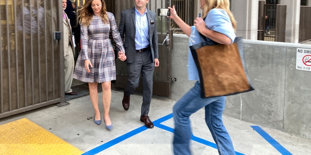 Danny Masterson holds his wife's hand following his November mistrial.