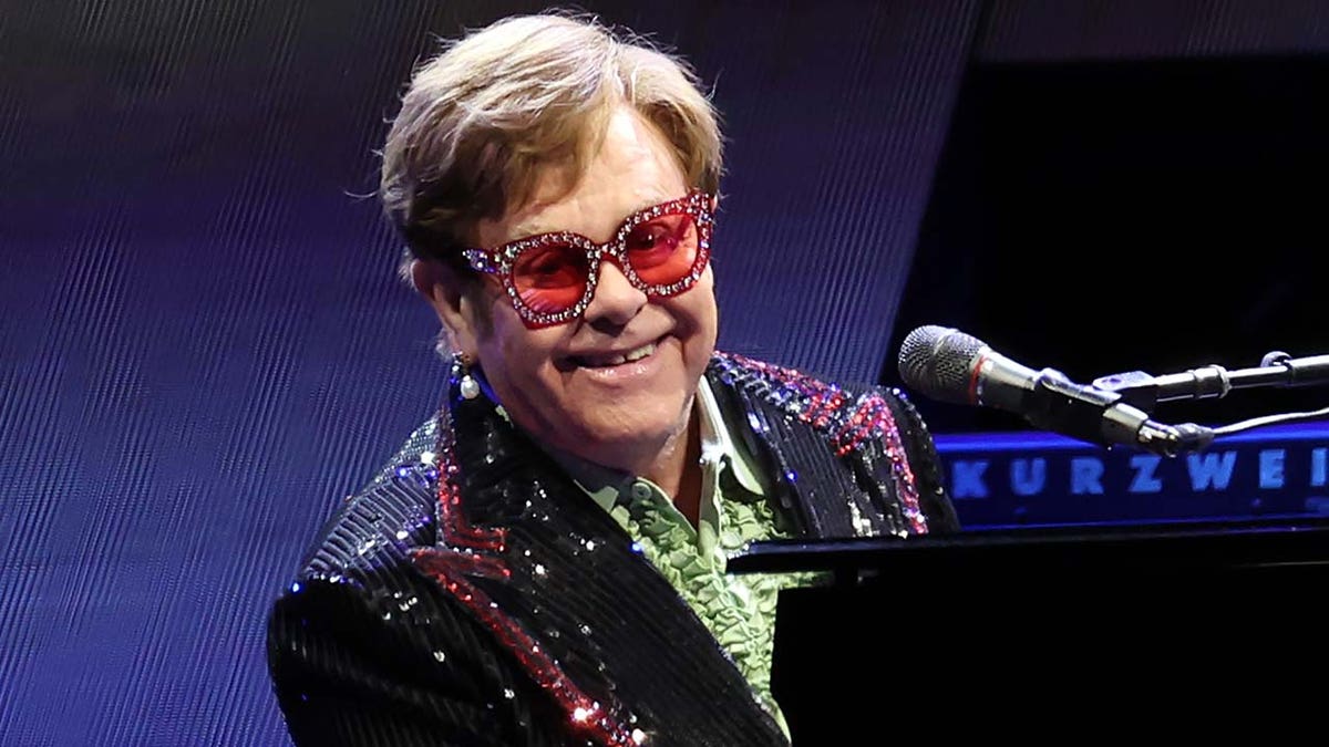 Elton John performs on stage