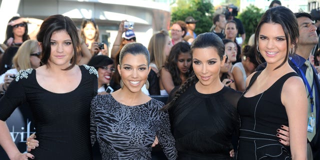 Kylie Jenner, Kourtney Kardashian, Kim Kardashian, and Kendall Jenner pose together on the red carpet