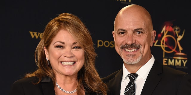 Valerie Bertinelli smiles with Tom Vitale in a striped tie at the Daytime Emmy AwardValerie Bertinelli smiles with Tom Vitale in a striped tie at the Daytime Emmy Awards in 2019s in 2019