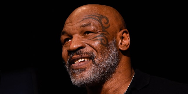 Mike Tyson shows off his face tattoo