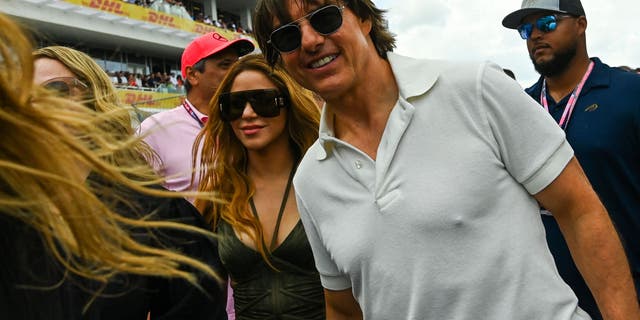 Tom Cruise and Shakira walk through a crowd together