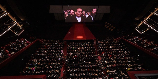 A birds eye view of the theater at Cannes which was previewing Johnny Depp's film, shows Depp on the big screen getting emotional