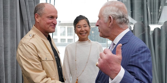 King Charles shakes hands with Woody Harrelson