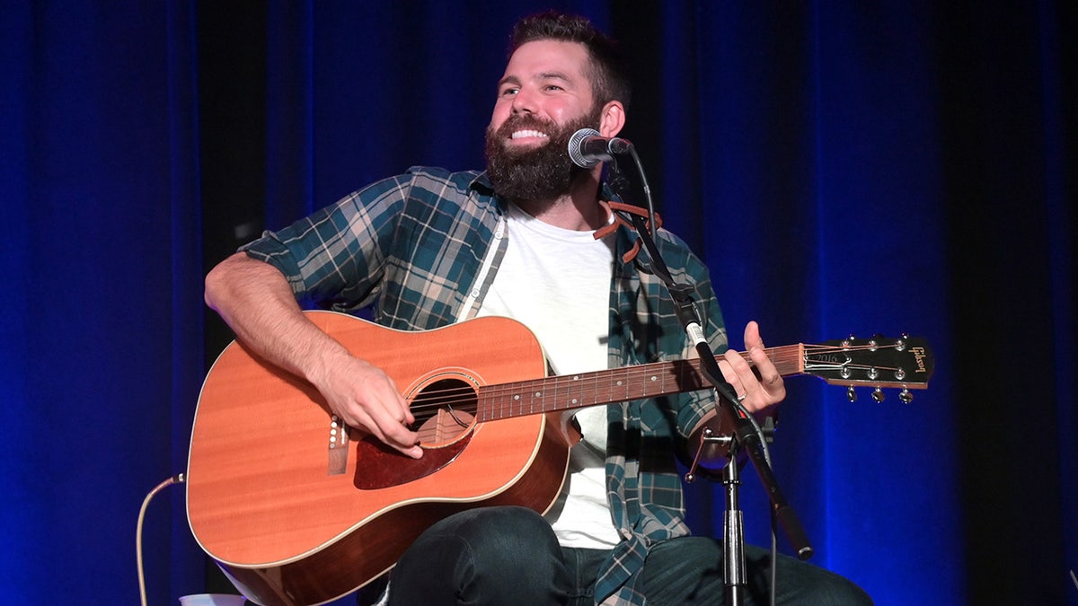 Jordan Davis with a guitar