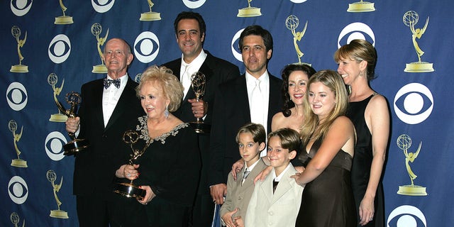 The cast of Everybody Loves Raymond, including Ray Romano, backstage with Emmy Awards