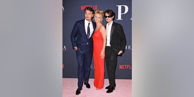 Brandon Thomas Lee, Pamela Anderson, and Dylan Jagger Lee pose together at the premiere of "Pamela, a love story"