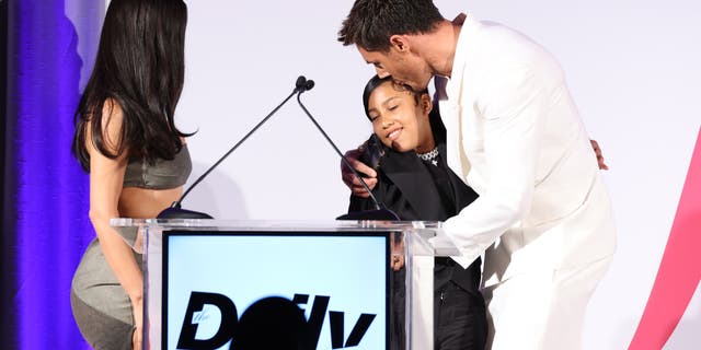 Kim Kardashian and North West on stage presenting to Chris Appleton