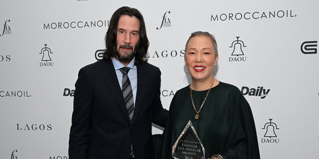 Keanu Reeves with stylist Jeanne Yang backstage