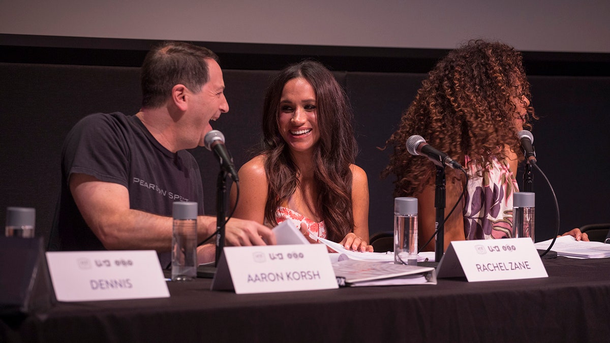 Aaron Korsh sitting with Meghan Makrle at a table