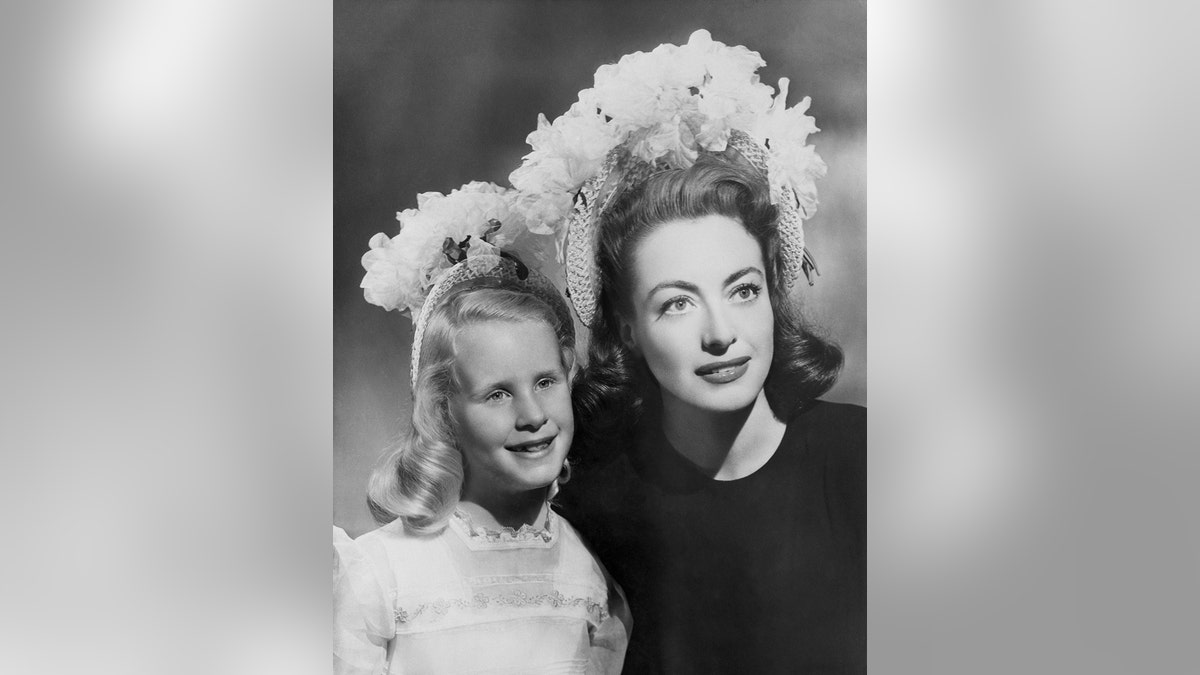 Joan Crawford wearing a matching fascinator with Christina Crawford