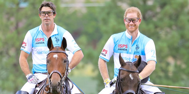 Ignacio Figueras and Prince Harry wearing matching polo uniforms while riding horses