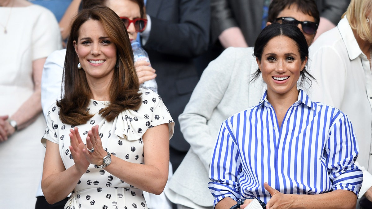 Kate Middleton wearing a polka dot dress and Meghan Markle wearing a blue and white striped shirt