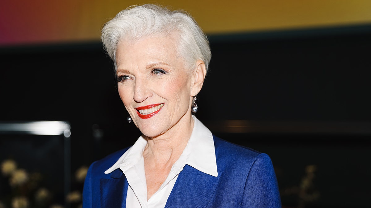 A close-up of Maye Musk wearing a blue blazer and white blouse