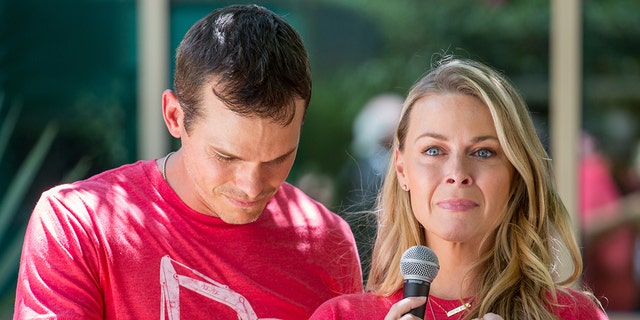 Granger Smith and his wife Amber Smith in tears while wearing red shirts