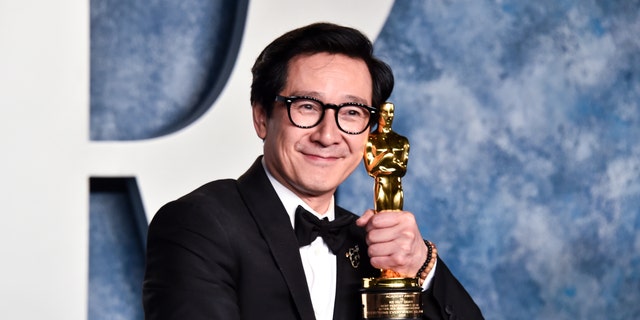 Ke Huy Quan poses with his Oscar