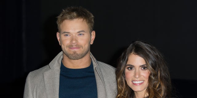 Kellan Lutz and Nikki Reed pose on the red carpet.