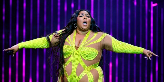 Lizzo in yellow outfit on stage