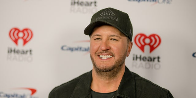 Close up of Lyke Bryan smiling wearing a baseball hat