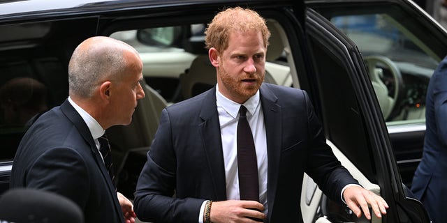 Prince Harry gets out of car at court