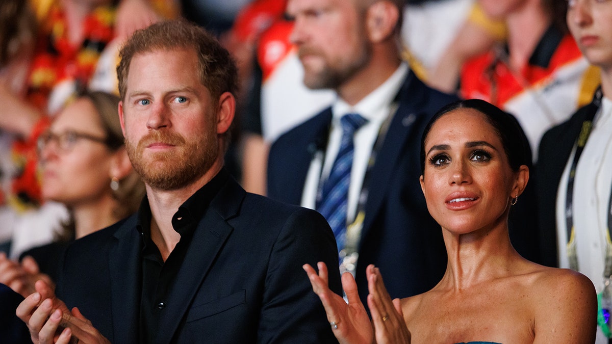 Prince Harry and Meghan Markle clapping