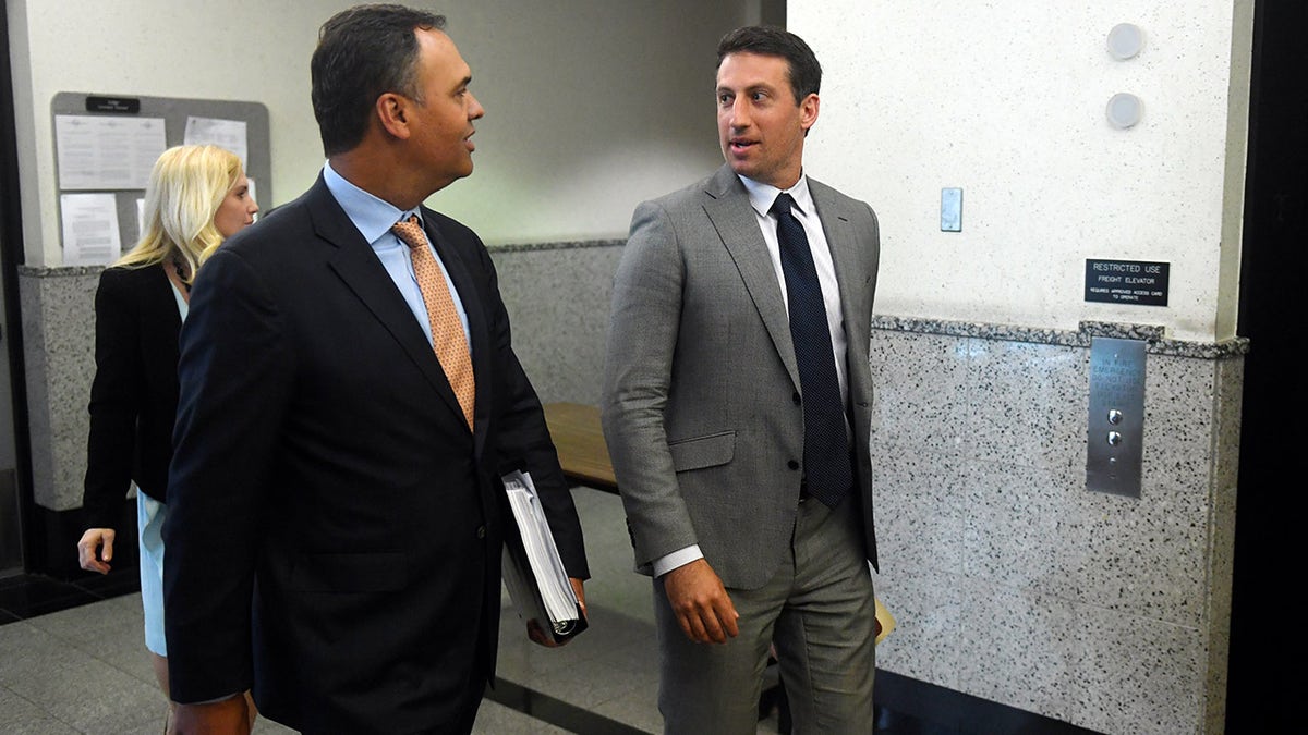 Lawyer Alex Spiro wears grey suit in court.