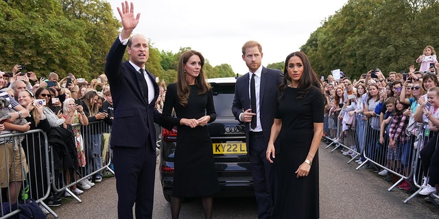 Kate Middleton, Prince William, Prince Harry and Meghan Markle standing in front of a car wearing black