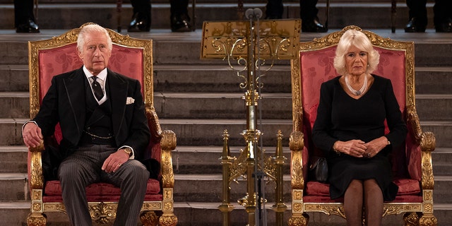 King Charles and Camilla, the queen consort sitting.