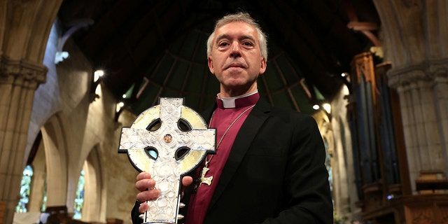 Archbishop of Wales holding the Cross of Wales