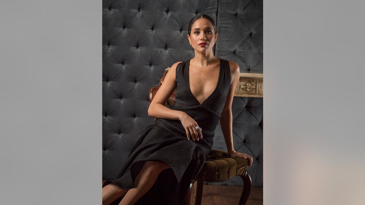 Meghan Markle wearing a low-cut black dress