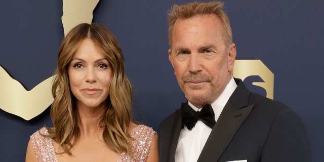 Kevin Costner and Christine Baumgartner walk red carpet at Hollywood event