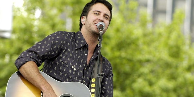 Luke Bryan wearing a printed black shirt in Detroit performing on stage in 2007