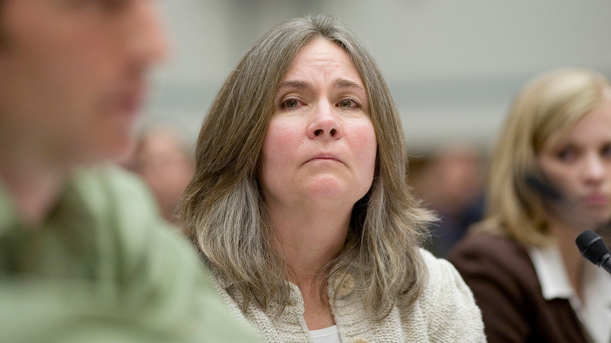 Mary Tillman in court looks serious as she looks at someone speaking