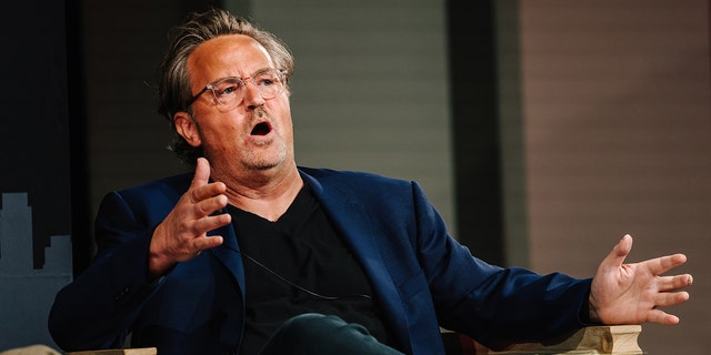 Matthew Perry wears blue blazer with black shirt and jeans at panel discussion