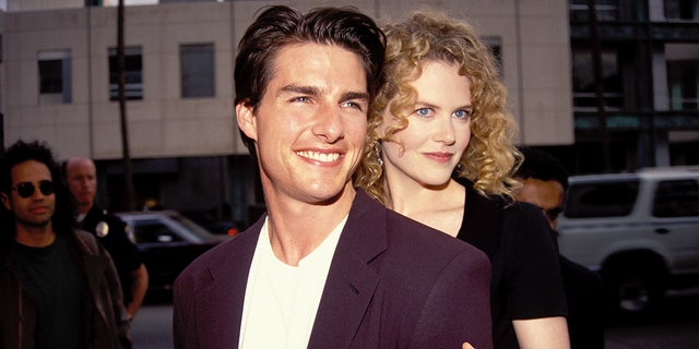 Nicole Kidman hugs husband Tom Cruise from behind