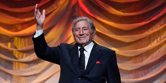 Tony Bennett on stage waving